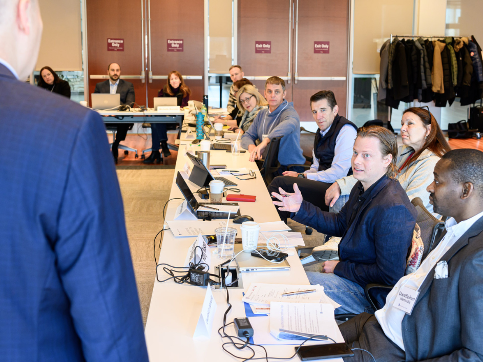 A group of professionals in a lecture hall.