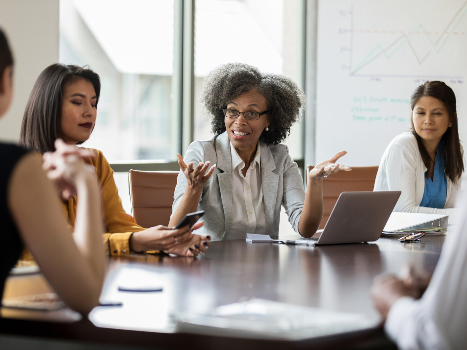 A senior professional discussing ideas during a business meeting.