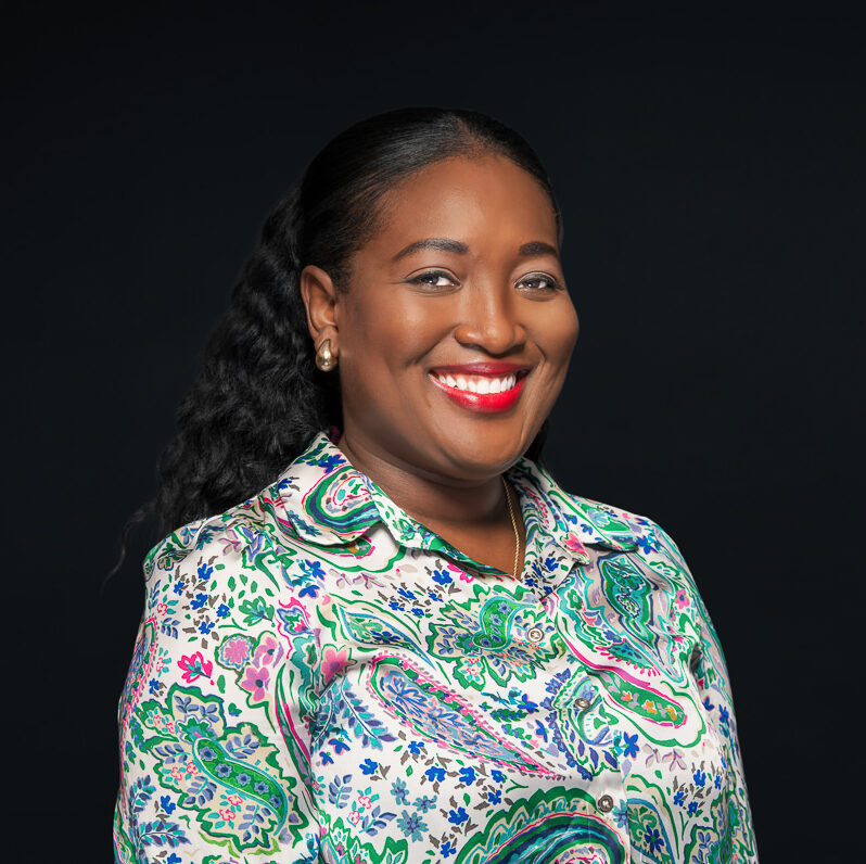 Morenike Akinyemi smiling in a colourful shirt